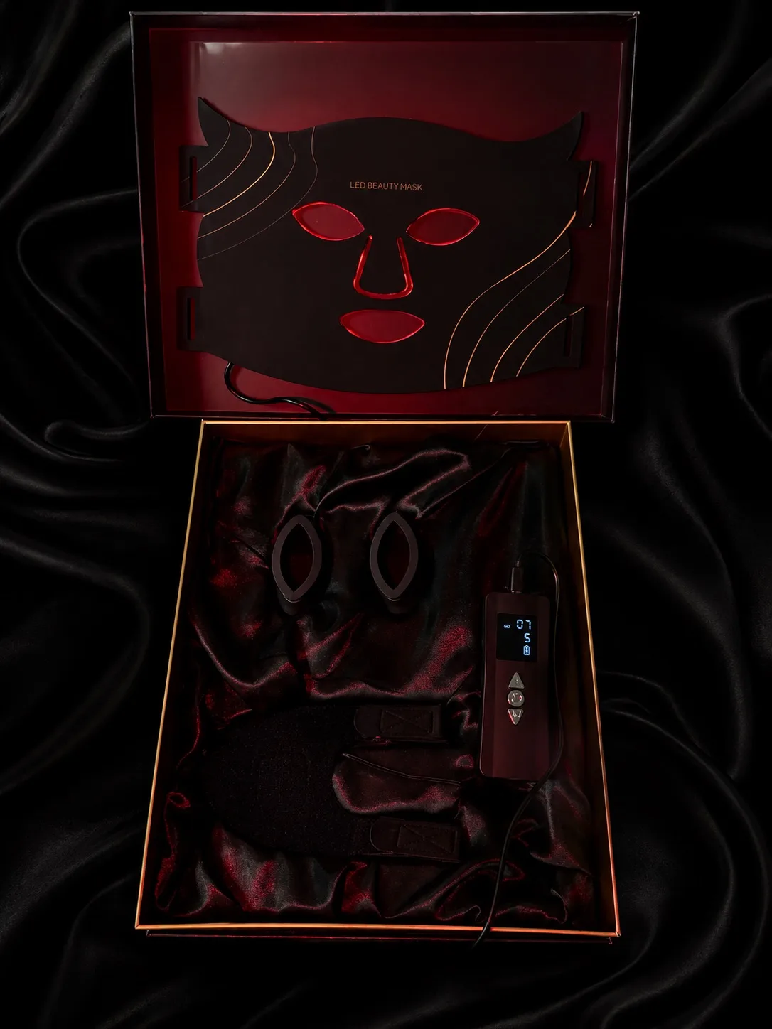The Aureum box, open: the mask in the lid, the eye cover, the controller and the straps nested in satin